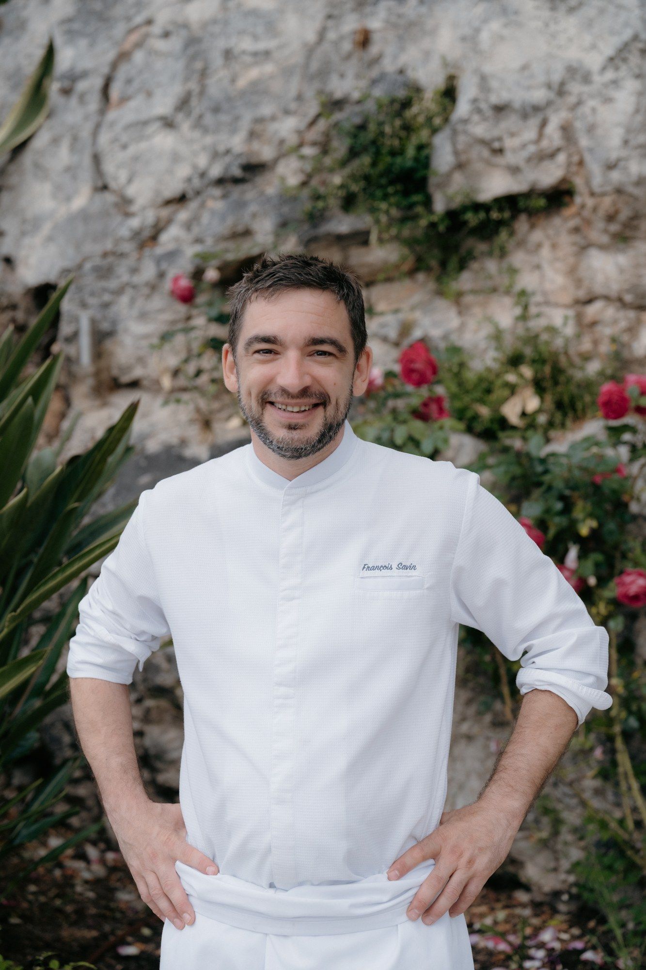 Chef François Savin in his whites on a Riviera villa terrace.