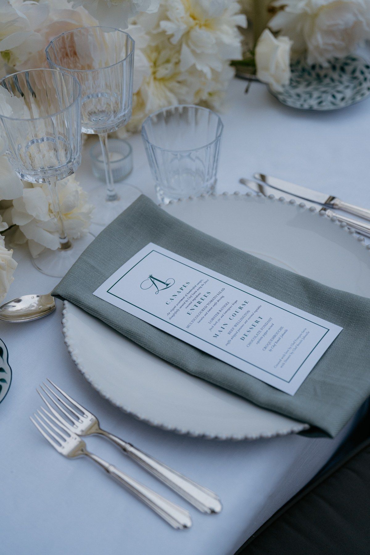 Cutlery, menu and tabletop detail on a villa terrace.
